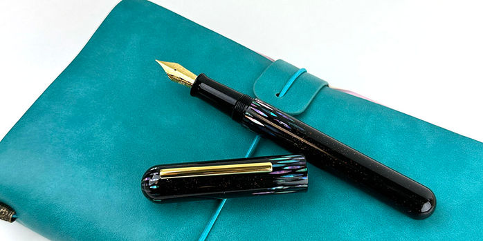 ye yu fountain pen_on_turquoise_notebook